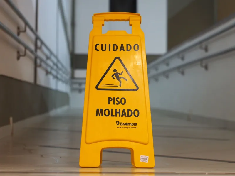 Caution: Your Brain Has Already Checked Out — The Glorious Stupidity of Ignoring Wet Floor Signs